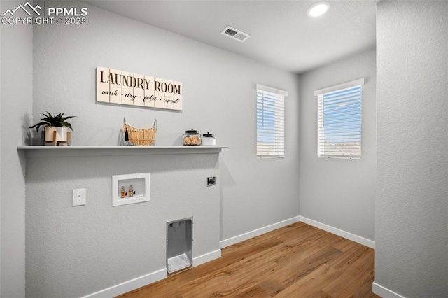 laundry room with hardwood / wood-style flooring, electric dryer hookup, and hookup for a washing machine