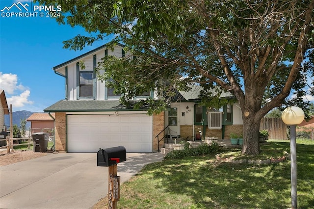 view of front of house with a front yard and a garage