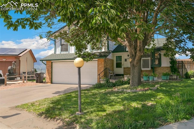 obstructed view of property with a garage and a front yard