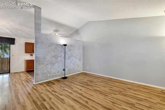 interior space with lofted ceiling, ceiling fan, and light hardwood / wood-style floors