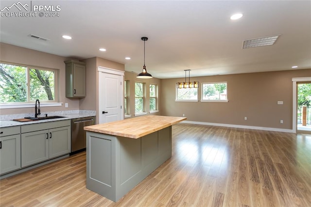 kitchen featuring dishwasher, a wealth of natural light, wood counters, and light hardwood / wood-style floors