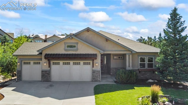 view of front of house with stone siding, driveway, and stucco siding