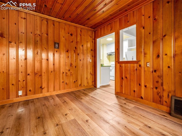 unfurnished room featuring light hardwood / wood-style flooring, wooden walls, and wood ceiling