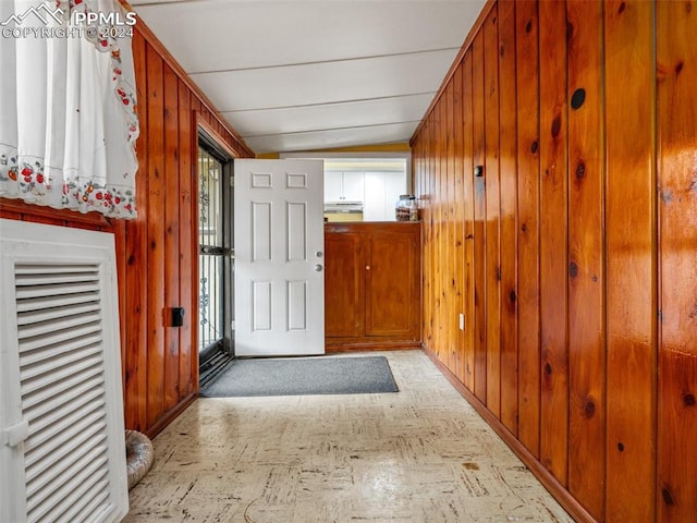 interior space featuring wood walls and a healthy amount of sunlight