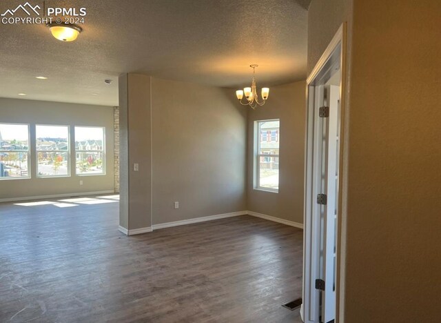 kitchen featuring appliances with stainless steel finishes, hanging light fixtures, light hardwood / wood-style flooring, a kitchen island with sink, and sink