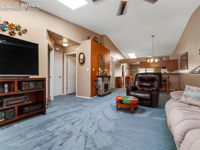 living room with ceiling fan with notable chandelier, carpet, and vaulted ceiling