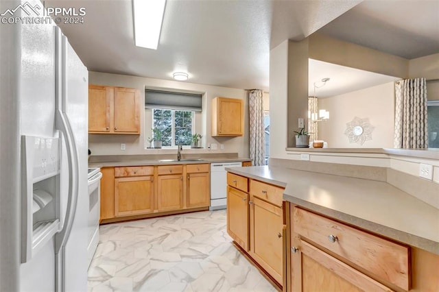 kitchen featuring sink, an inviting chandelier, white appliances, light brown cabinets, and light tile patterned floors