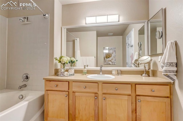 bathroom with shower / bath combo with shower curtain and vanity