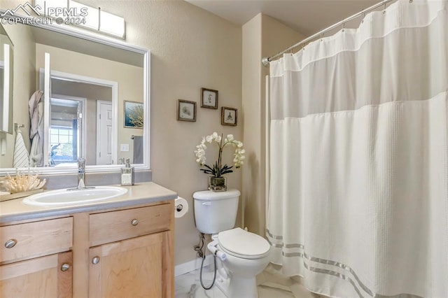 bathroom with tile patterned flooring, toilet, vanity, and curtained shower