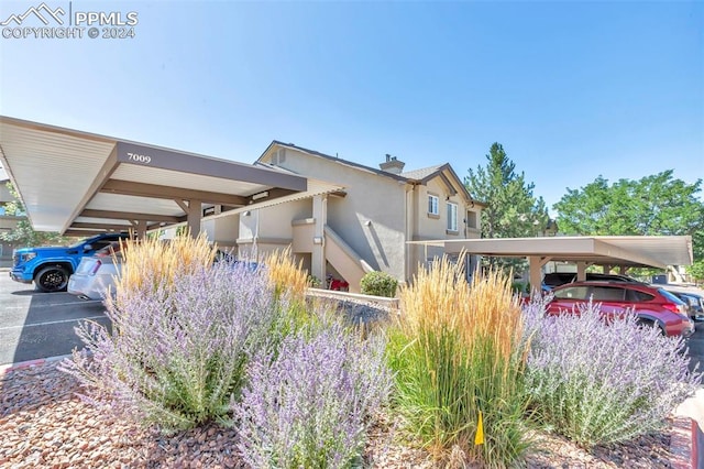 view of front of property featuring a carport