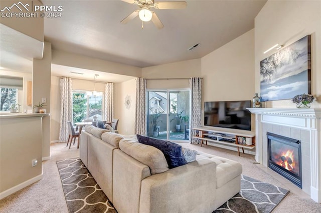 carpeted living room featuring ceiling fan and a tile fireplace