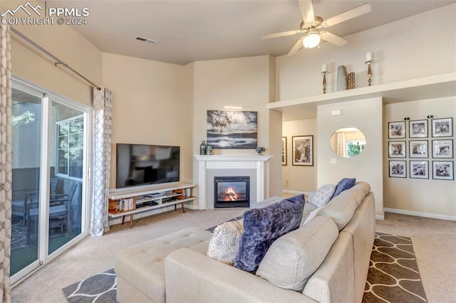 carpeted living room with plenty of natural light and ceiling fan