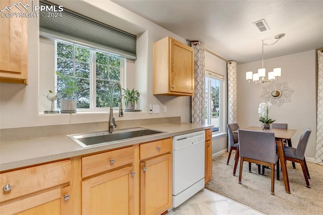 kitchen featuring a wealth of natural light, white dishwasher, and light brown cabinets