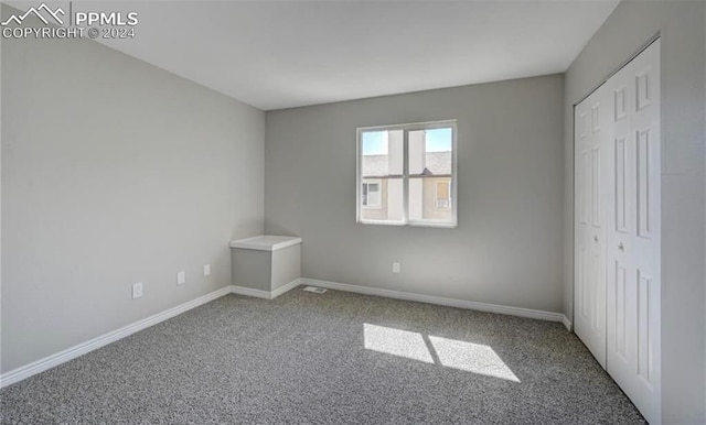 unfurnished bedroom with a closet and carpet