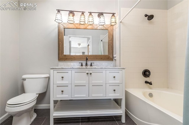 bathroom with baseboards, toilet,  shower combination, tile patterned flooring, and vanity