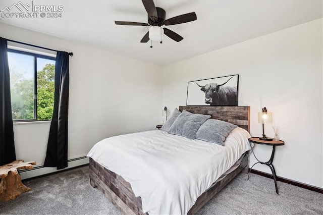 carpeted bedroom with ceiling fan and baseboard heating