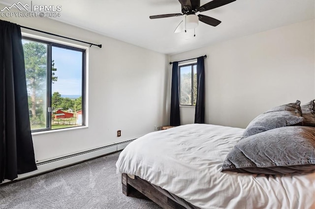 bedroom featuring ceiling fan, a baseboard heating unit, and carpet flooring