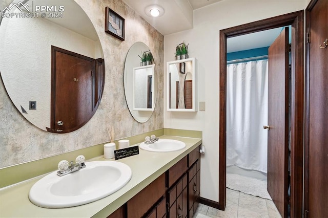 bathroom with tile patterned flooring and double sink vanity