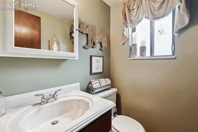 bathroom featuring vanity and toilet