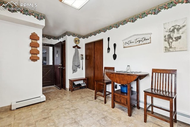 dining room with a baseboard radiator and light tile patterned flooring