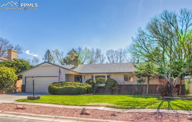 ranch-style house with a garage and a front yard