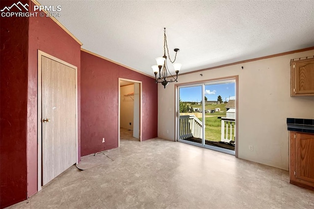 unfurnished dining area featuring ornamental molding, lofted ceiling, a notable chandelier, and a textured ceiling