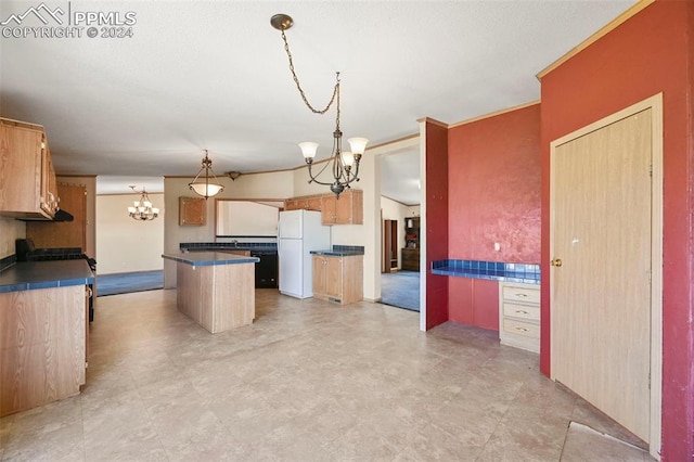 kitchen featuring a kitchen island, a notable chandelier, light tile patterned floors, and white refrigerator