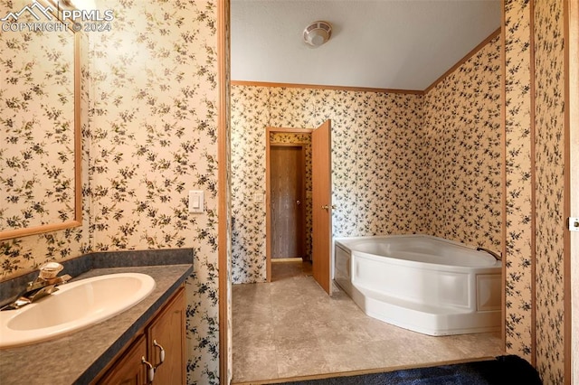 bathroom featuring tile patterned flooring, a garden tub, vanity, and wallpapered walls