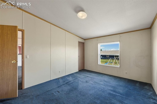 carpeted spare room featuring a textured ceiling and ornamental molding