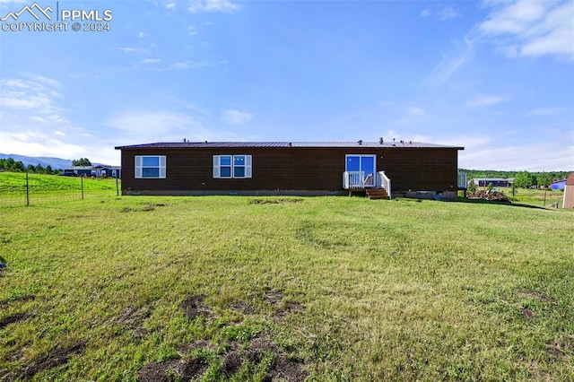 back of house with a lawn