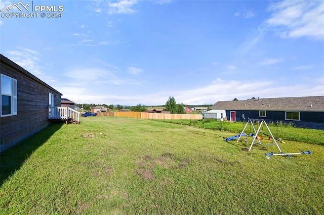 view of yard with a playground and fence