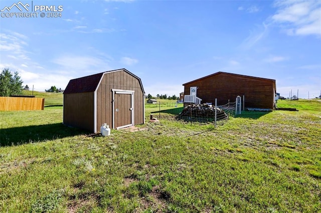 view of outdoor structure with a rural view and a lawn