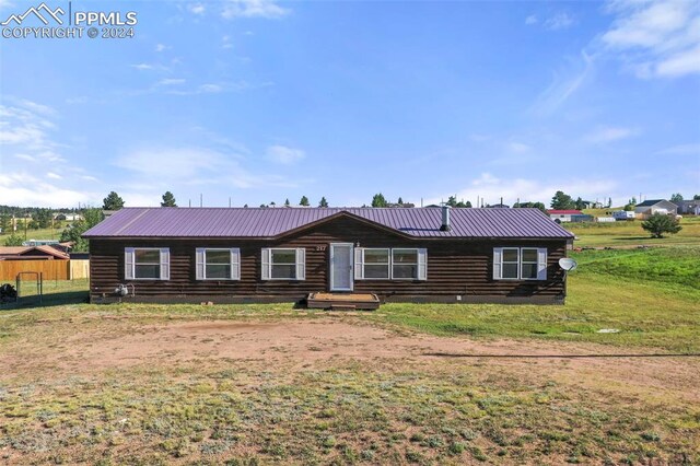 log-style house with a front lawn