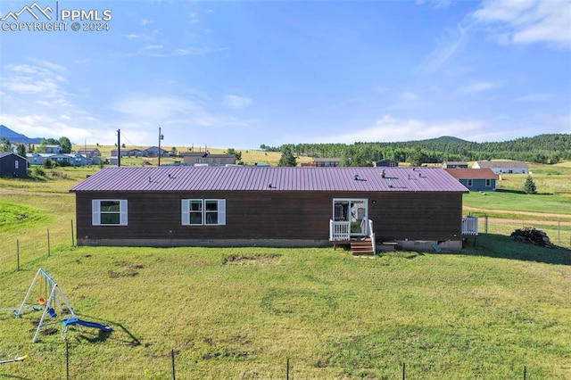 view of front of home featuring entry steps, crawl space, fence, and a mountain view