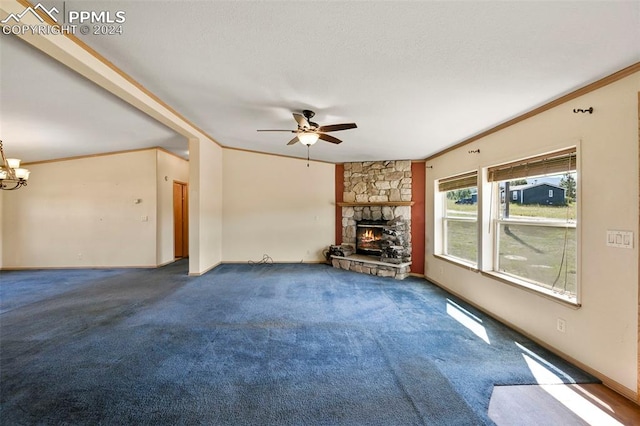 unfurnished living room featuring ceiling fan with notable chandelier, ornamental molding, baseboards, and a stone fireplace