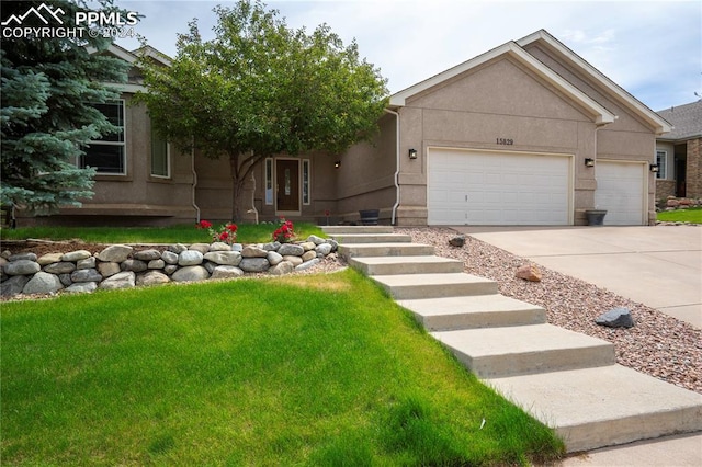 view of front facade with a front yard and a garage