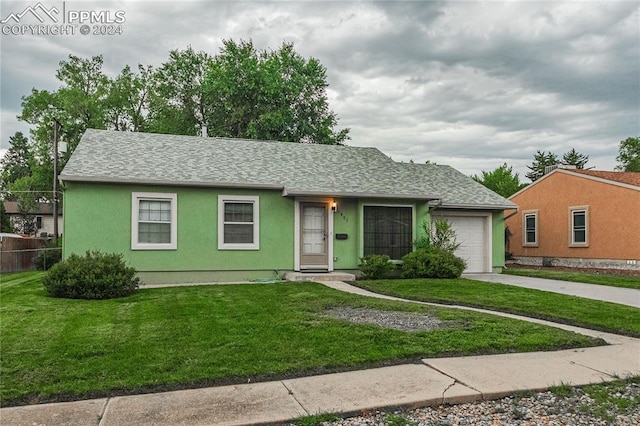 single story home with a garage and a front lawn