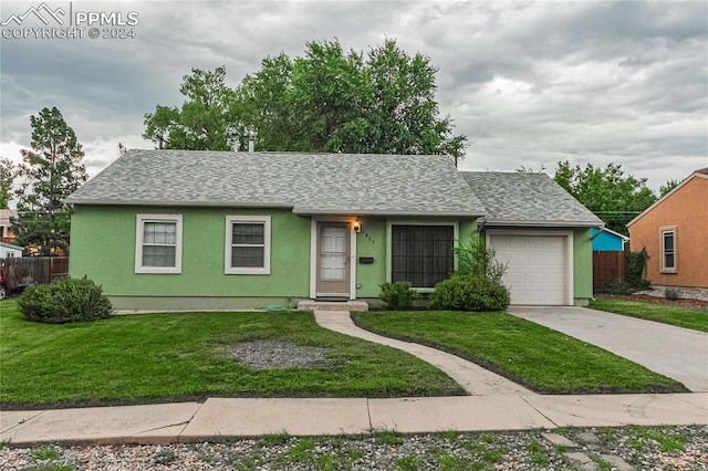 ranch-style house featuring a garage and a front yard