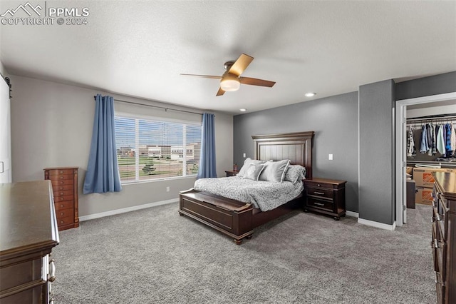 bedroom featuring light carpet, a closet, and ceiling fan