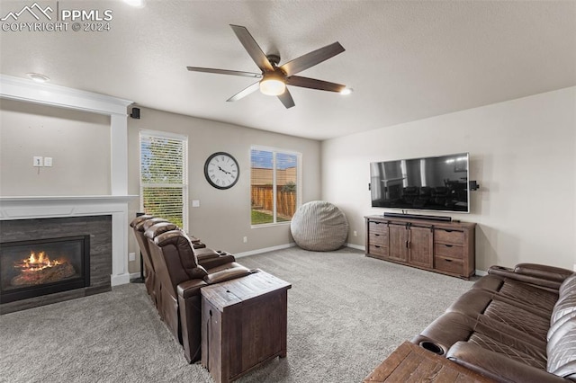 living room featuring ceiling fan, carpet, and a fireplace