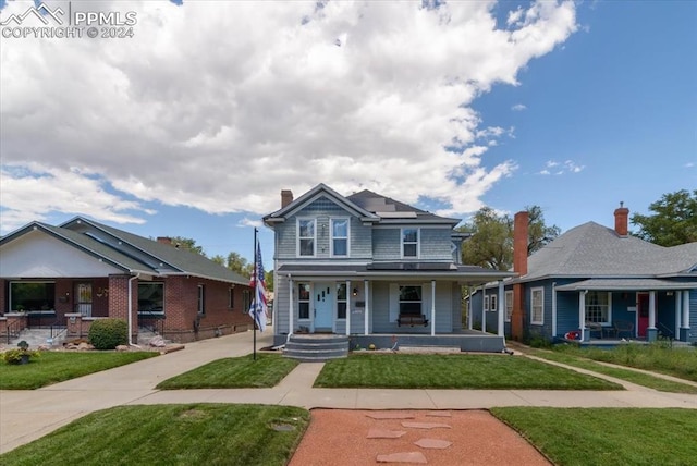 view of front of property featuring a porch and a front lawn