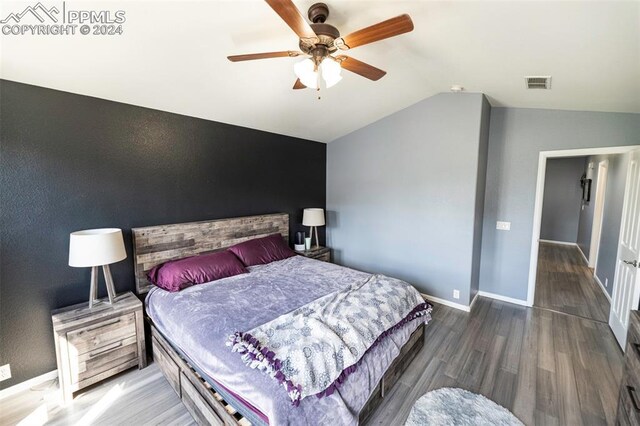 bedroom featuring ceiling fan, lofted ceiling, and wood-type flooring