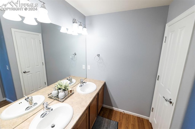 bathroom with hardwood / wood-style floors and dual bowl vanity