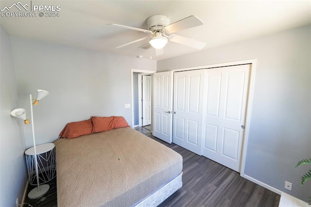 bedroom with ceiling fan, dark wood-type flooring, and a closet