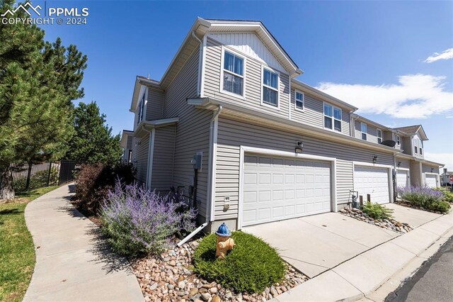 view of side of home featuring a garage