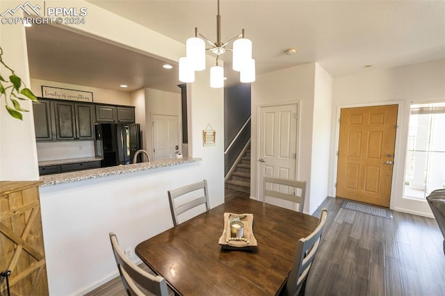 dining room featuring a chandelier and dark hardwood / wood-style flooring