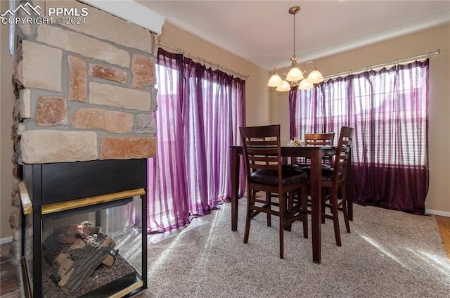 dining room featuring an inviting chandelier and a fireplace