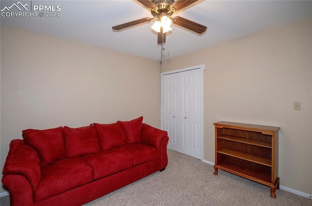 carpeted living room featuring ceiling fan