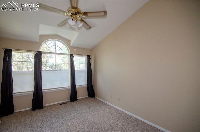 carpeted empty room featuring ceiling fan and vaulted ceiling