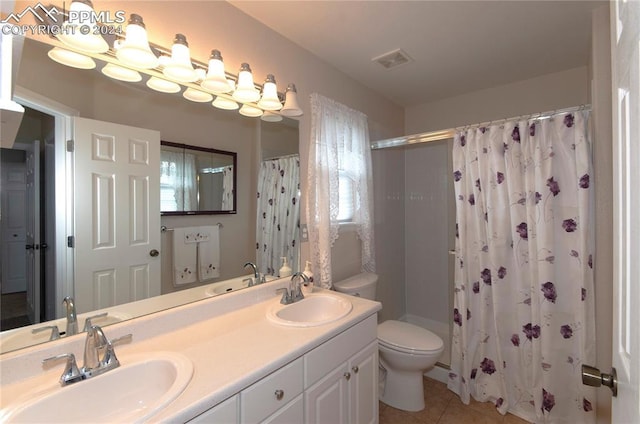 bathroom featuring walk in shower, tile patterned floors, vanity, and toilet